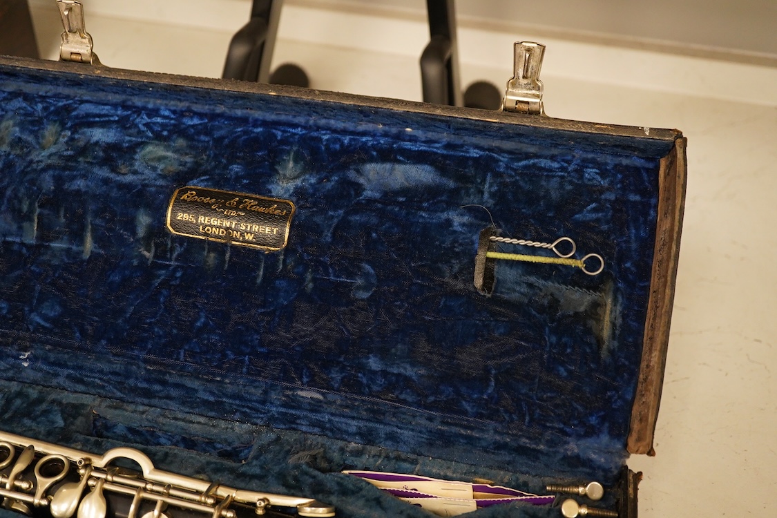 An early 20th century wooden Boosey and Hawkes clarinet in a fitted leather case